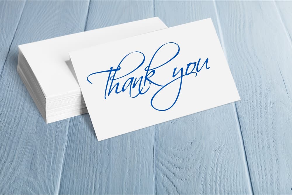 Thank you note in blue written in cursive