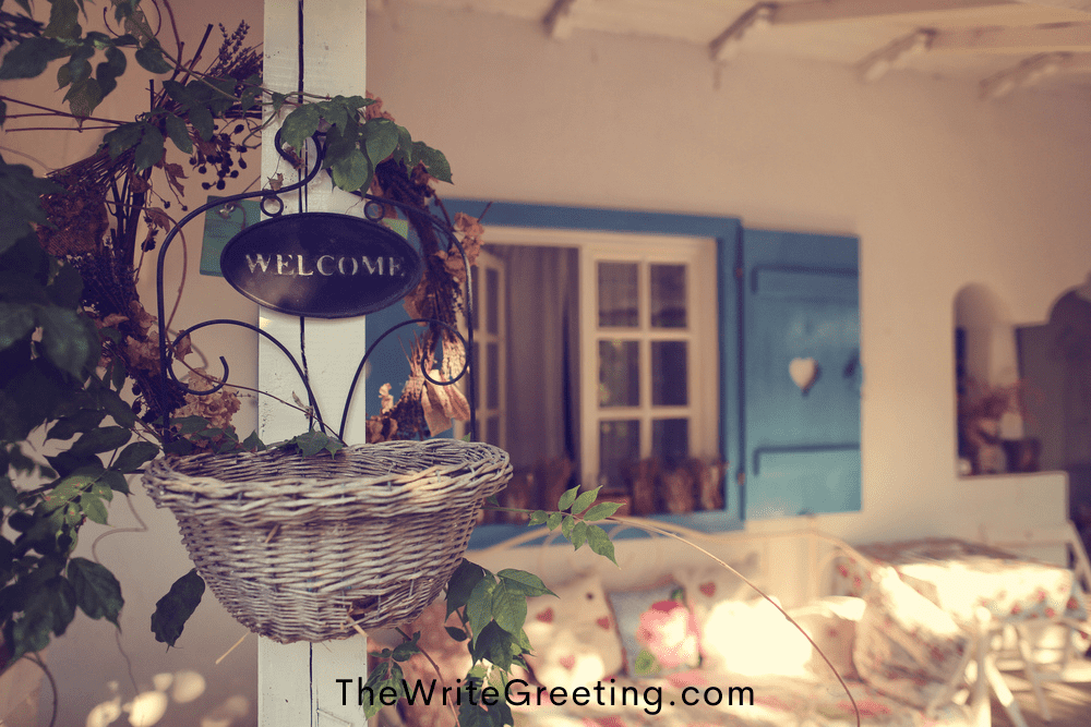 A home with blue shutters and a welcome sign