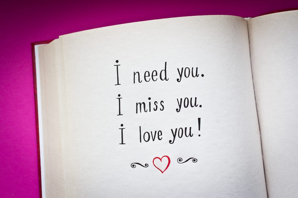 love messages written on a notebook with pink background