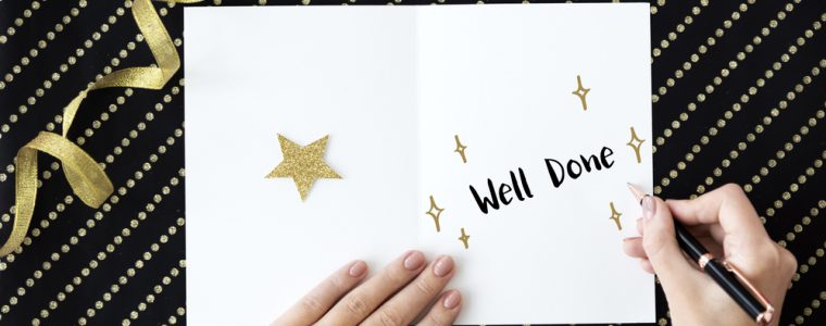 the words well done written in white card