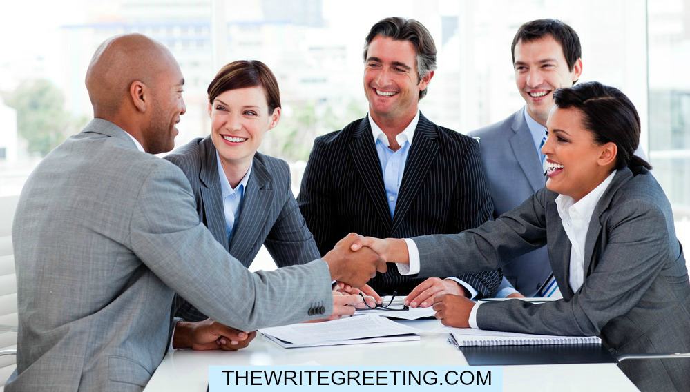 Work colleagues shaking hands for promotion