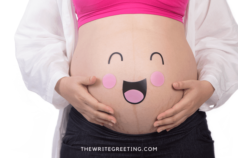 Pregnant womans belly with face drawn on