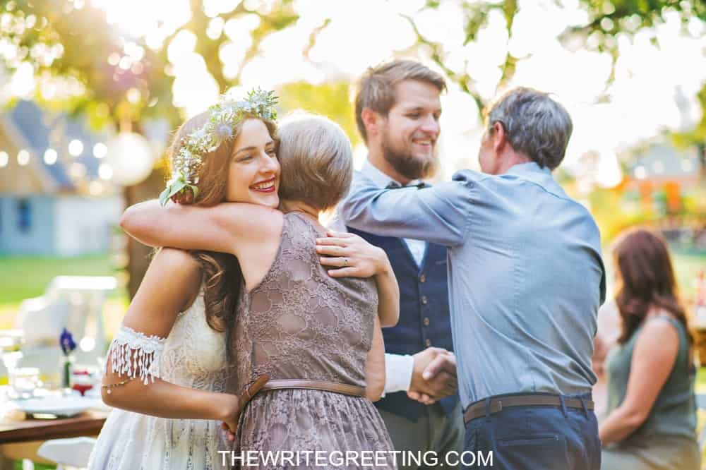 bride and groom hugging parents