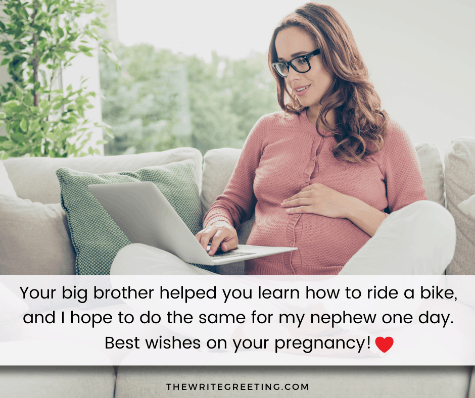 pregnant woman sitting on couch on computer