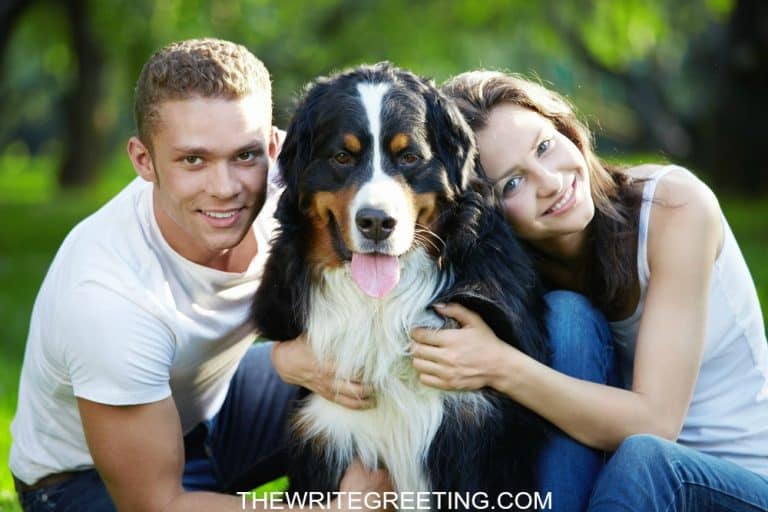 A young couple loving on their dog