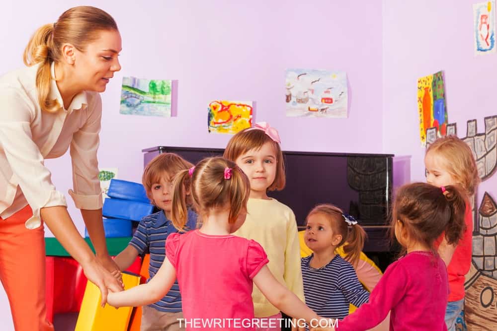 Nursery teacher having fun with her kids