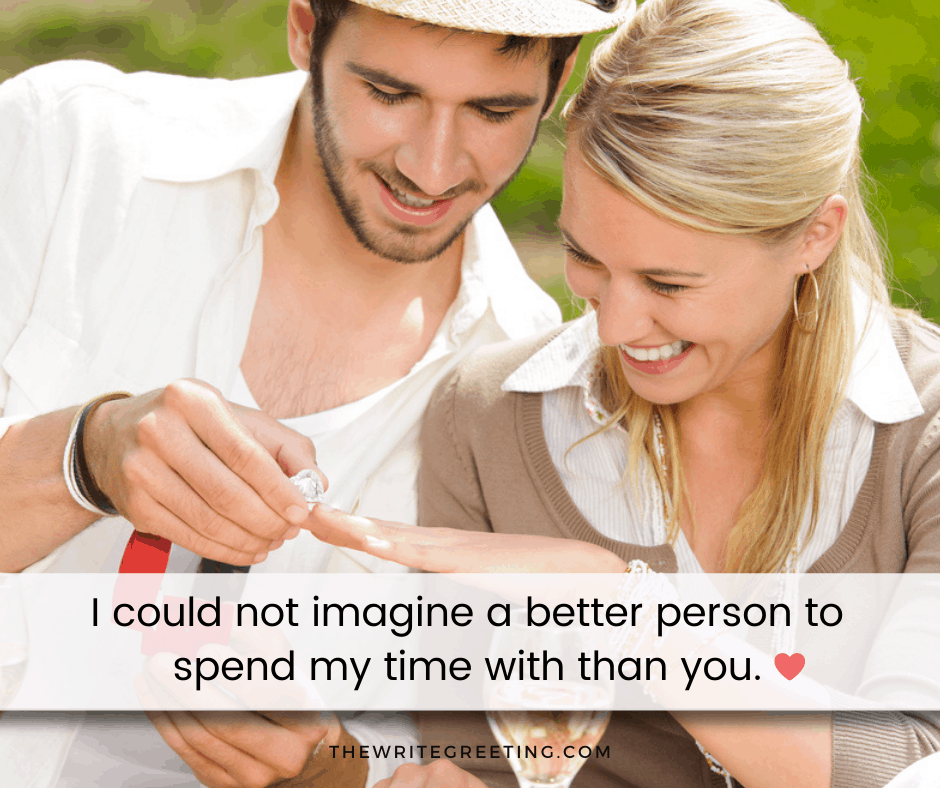 man and woman looking happily at engagement ring