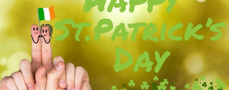 Patricks day fingers with irish flag on green background