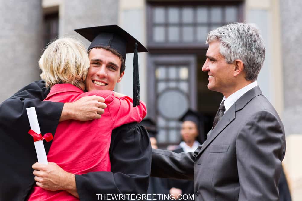 happy male graduate hugging his mother at graduation ceremony