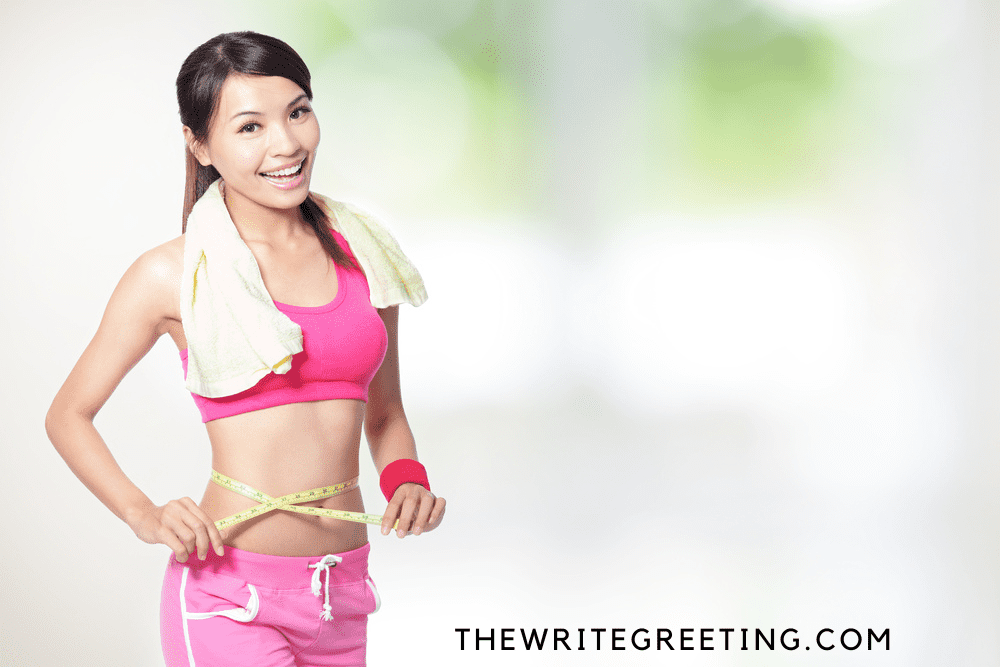 Woman in workout gear & measuring tape around waist