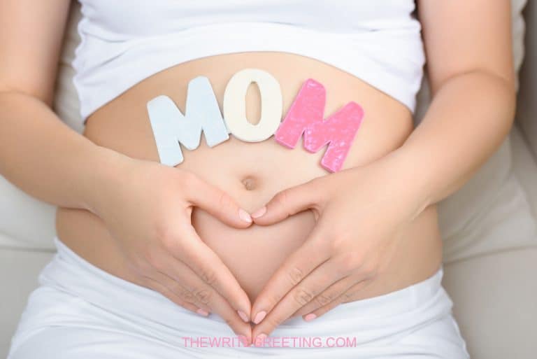 Woman showing pregnant belly with heart sign