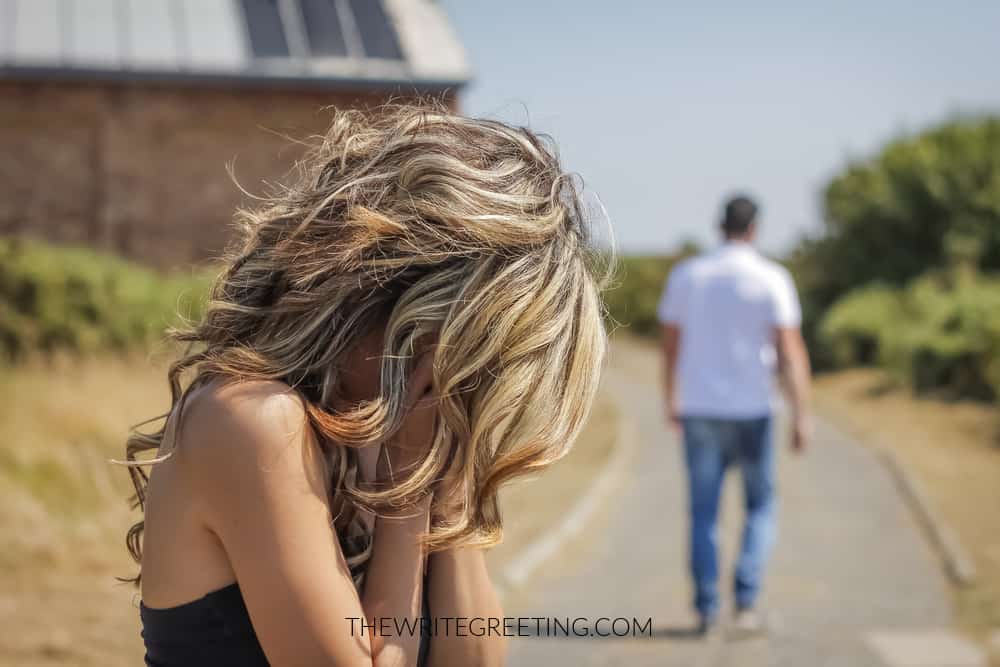 Woman crying as ex boyfriend walks away