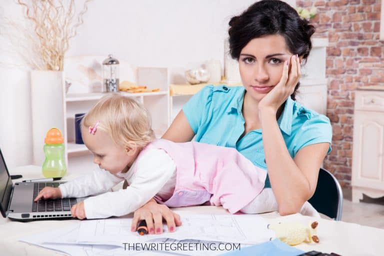Young busy mom with laptop and her baby girl