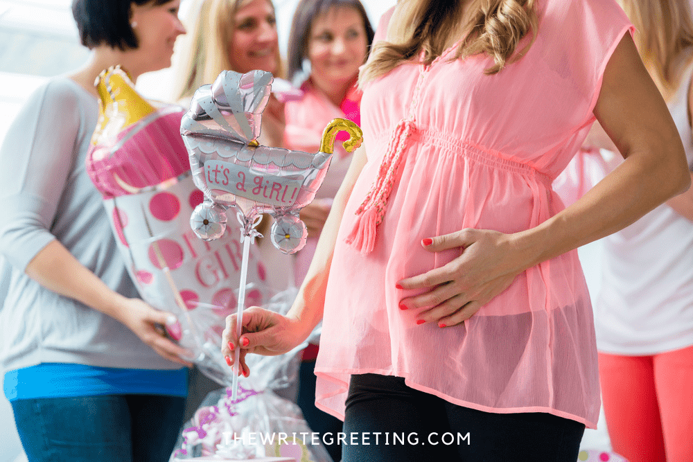Beautiful pregnant woman at baby shower in pink