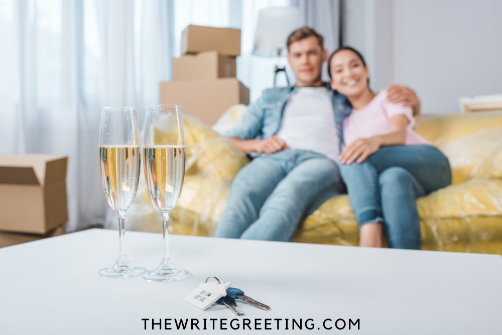Young couple celebrating new home with champagne