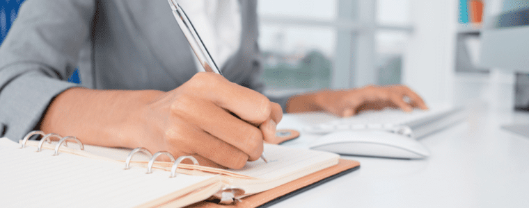 Administrative professional writing in notebook