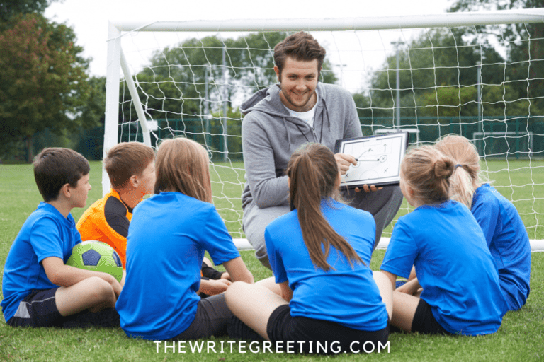 Soccer coach talking to young girls in blue uniform