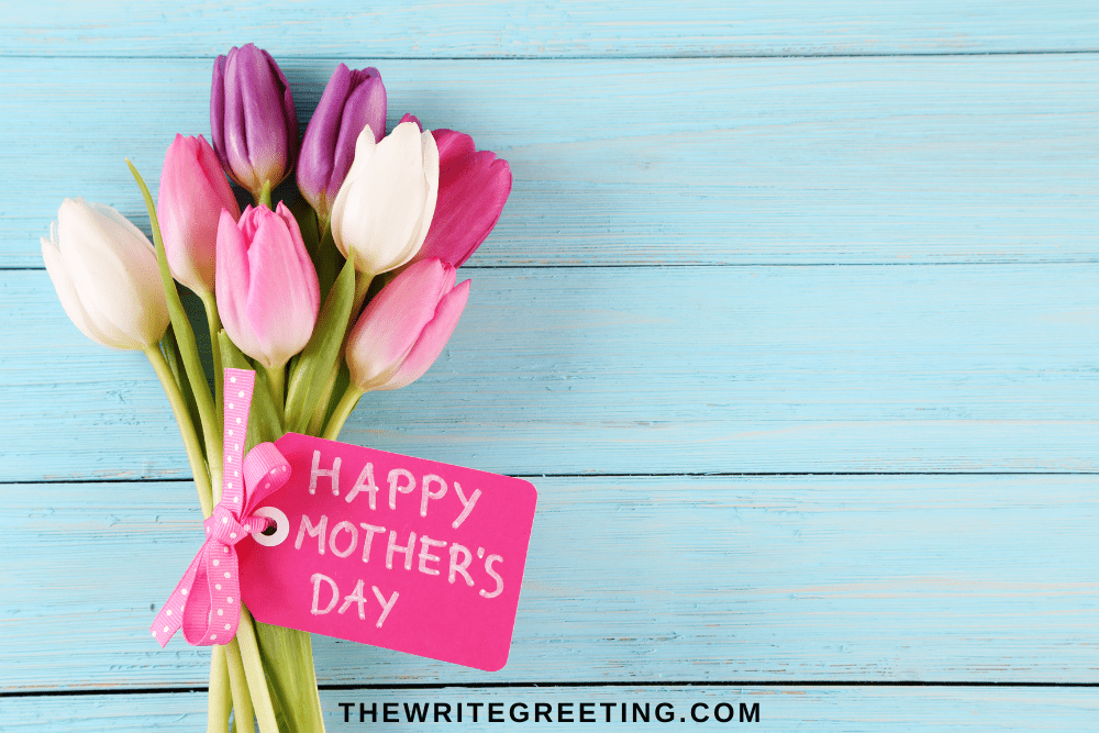 Pink, purple, white tulips with happy mothers day sign in pink