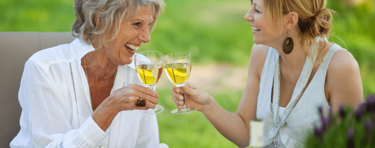 Daughter and mother in law drinking wine outdoors