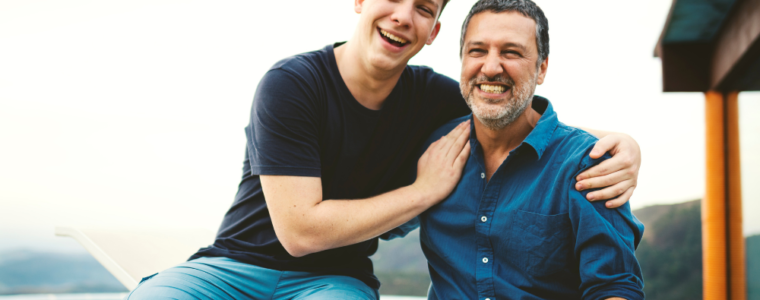 Dad and teenage son smiling