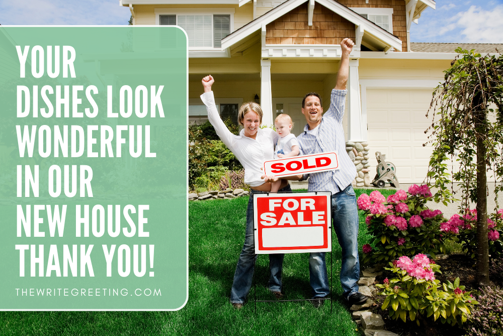 New Home owners standing by sold sign