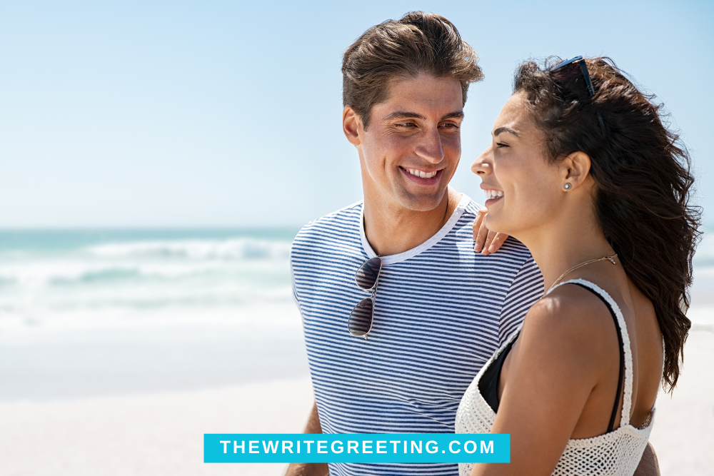 Man in blue striped shirt staring at girlfriend at beach
