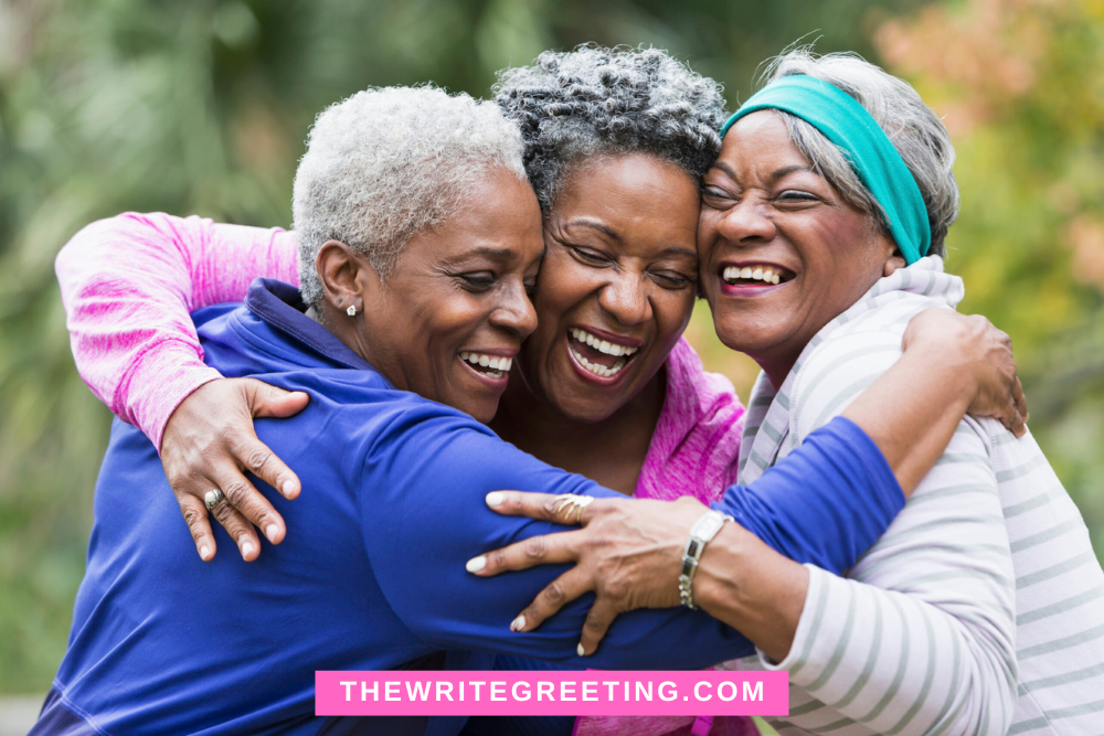 A group of 3 African American women hugging and supporting each other