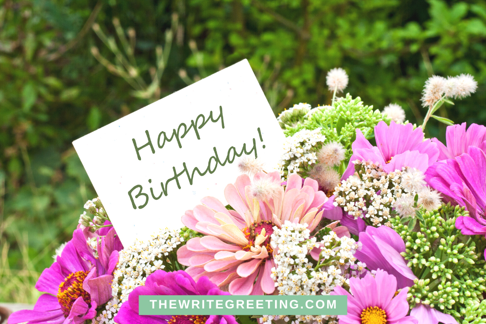 Happy birthday written on a card with pink flowers