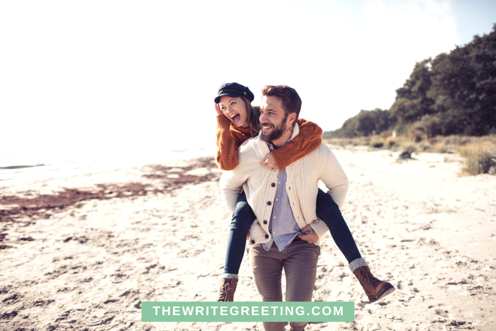 Couple hanging out on beach in fall clothes
