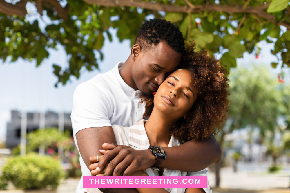 African American couple cuddling outdoors