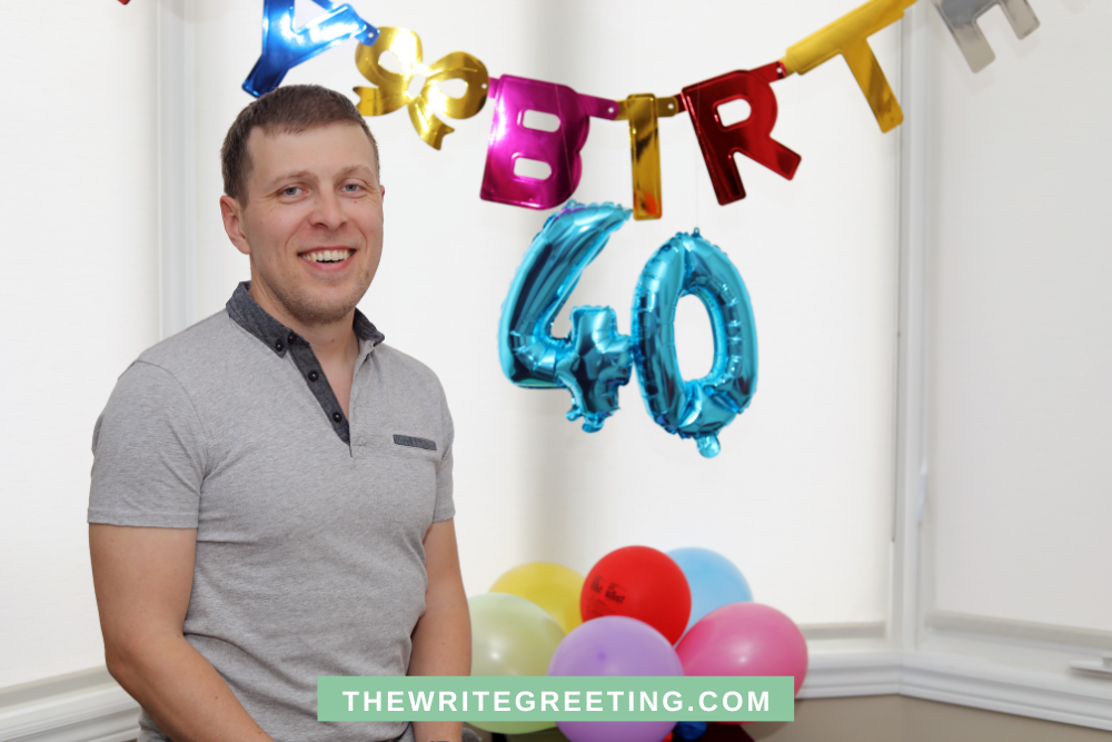 Man standing in front of birthday 40 banner