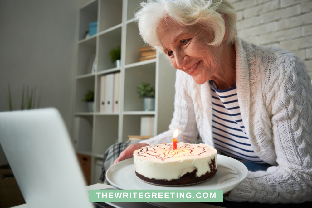 80 year old woman presenting birthday cake