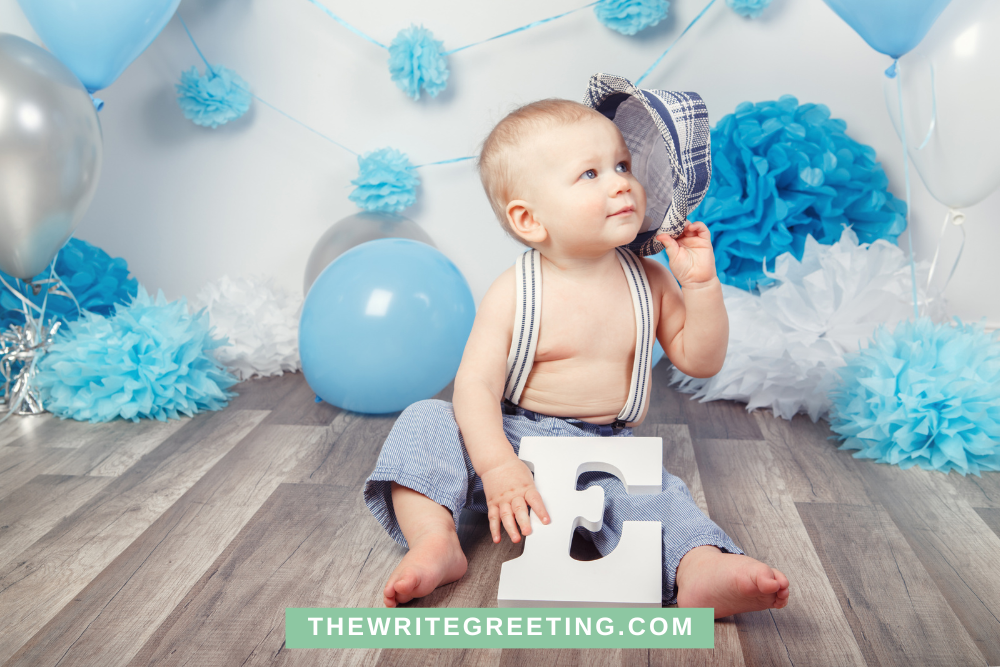 One year old boy in blue with blue balloons