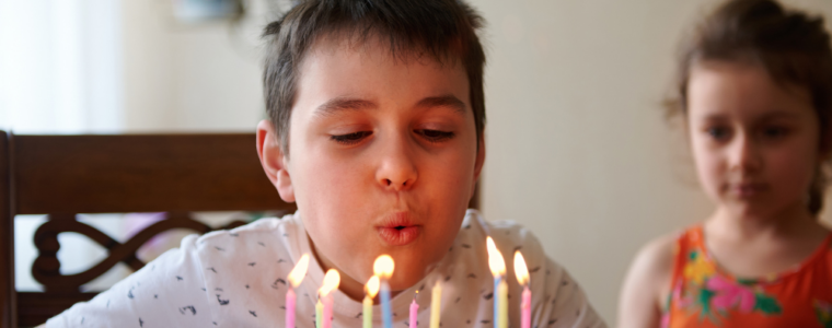 A 10 year old blowing out candles