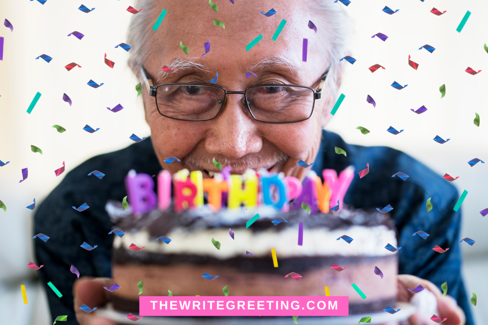 Older man behind cake with happy birthday on it