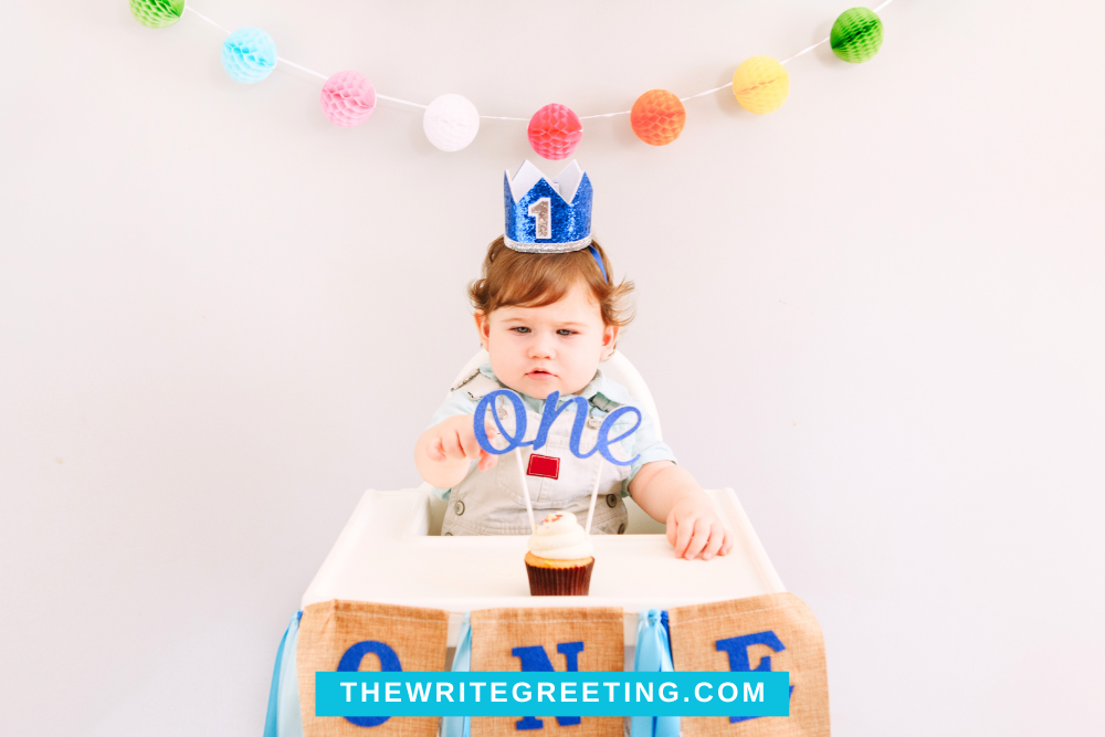 One year old little boy celebrating birthday in high chair
