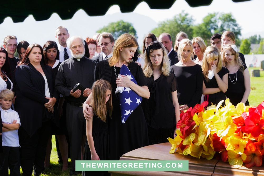 Mom and daughter at funeral with American flag