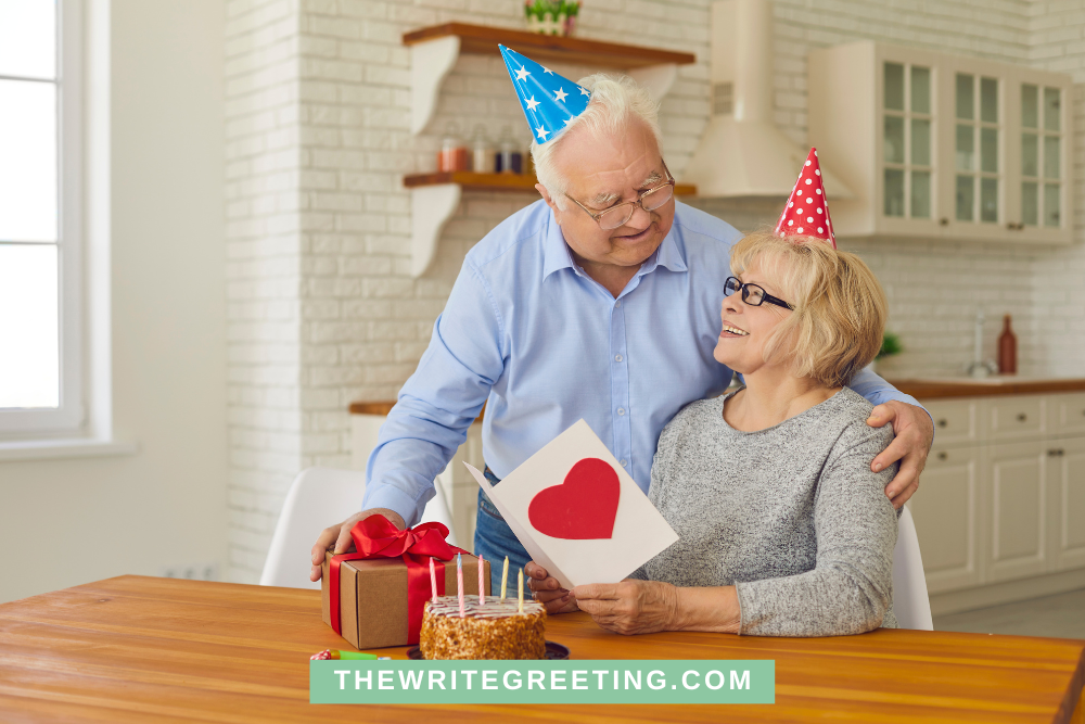 Older man giving his wife a red gift box on her birthday