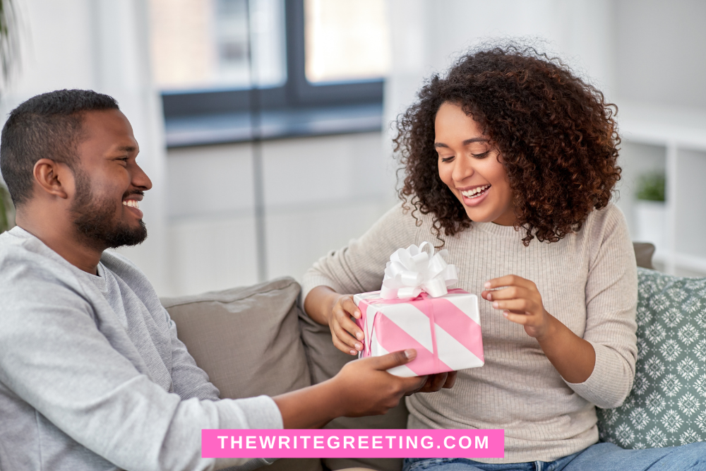 African American man giving wife a birthday present